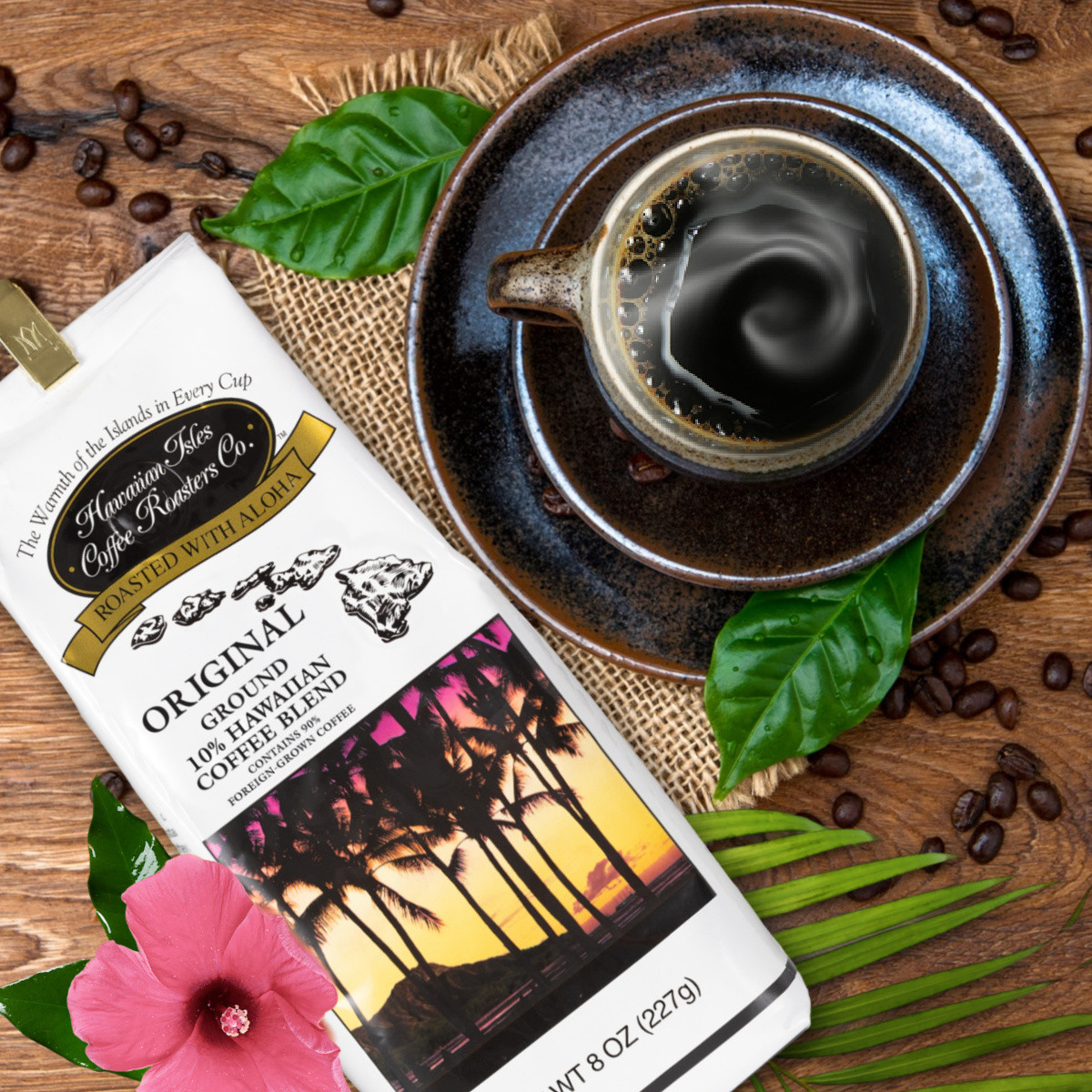 Bag of Original Roast coffee laying on table next to a pink flower and coffee cup